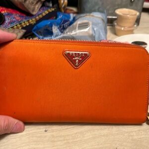 Prada.  Orange zipper closure no outside pockets